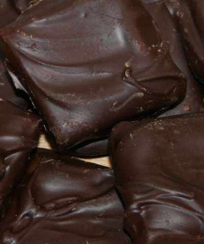 Dark chocolate butter toffee pieces with rich, buttery texture in a white gift box