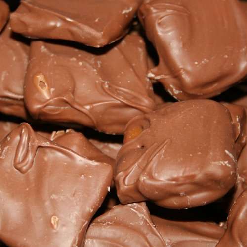Close-up of Butter Toffee Covered in Milk Chocolate pieces in a white gift box with free shipping label