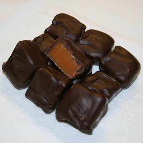 Box of artisanal dark chocolate covered caramels with rich caramel center and smooth chocolate coating