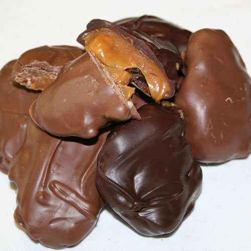 Close-up of Caramel Pecan Clusters Covered in Chocolate with caramel, pecans, and dark chocolate coating