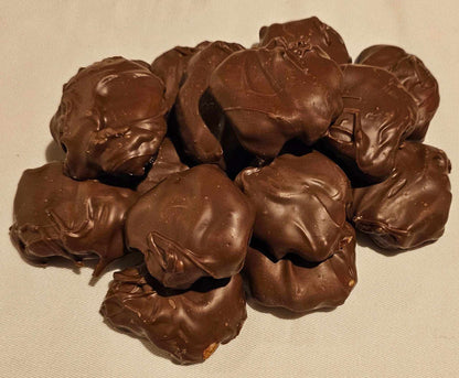 Caramel pecan clusters covered in rich dark chocolate with buttery caramel and crunchy pecans